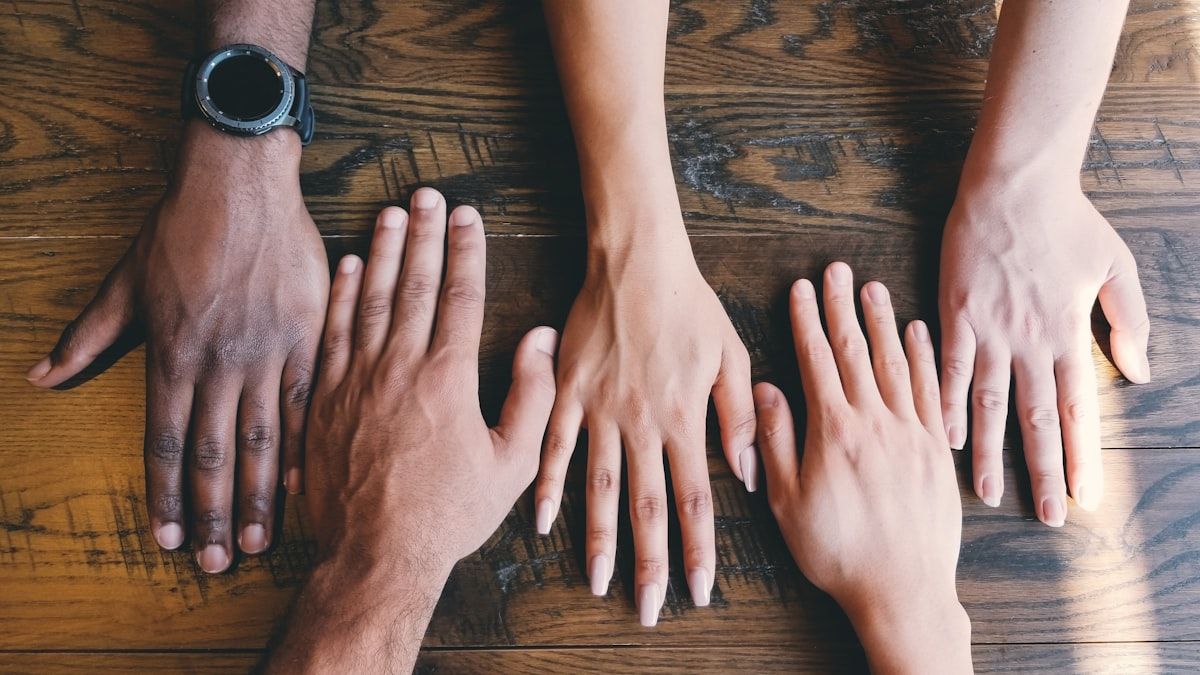 人とチームの協働を象徴する複数の手